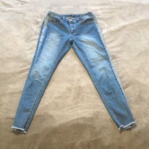 Blue jeans with frayed ankle
